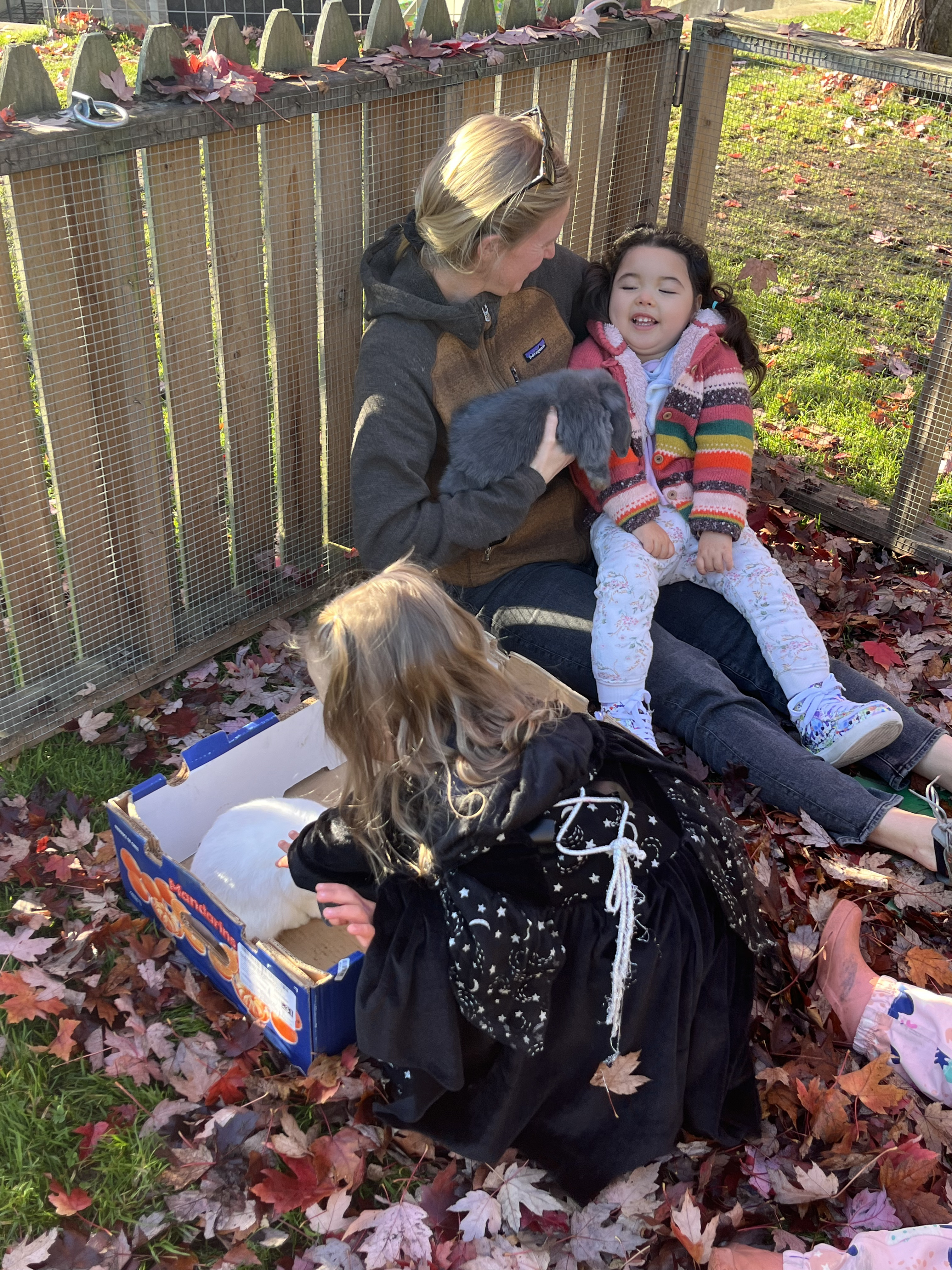 child and teacher with a bunny outside